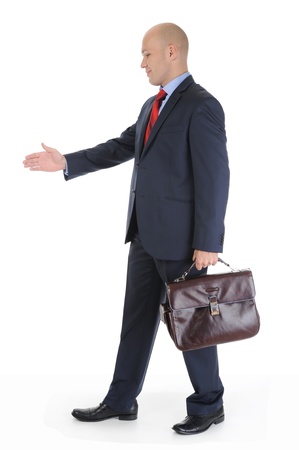 Businessman in full-length stretches out his hand for a handshake. Isolated on white backgroundの写真素材