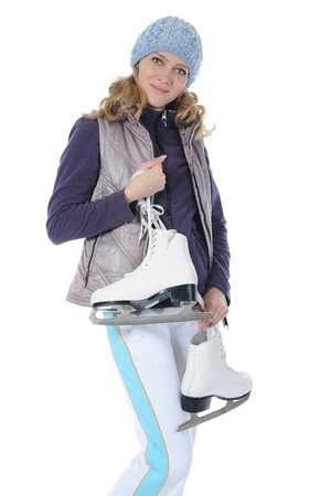 Young smiling woman with skates in studio. Isolated on white backgroundの写真素材