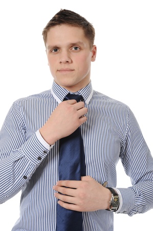 picture of a businessman adjusting his tie. Isolated on white backgroundの写真素材
