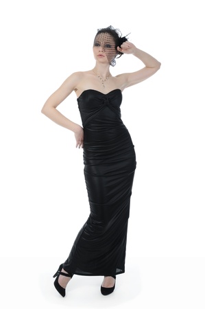 Young beautiful woman in a full-length in evening gown. Isolated on white backgroundの写真素材