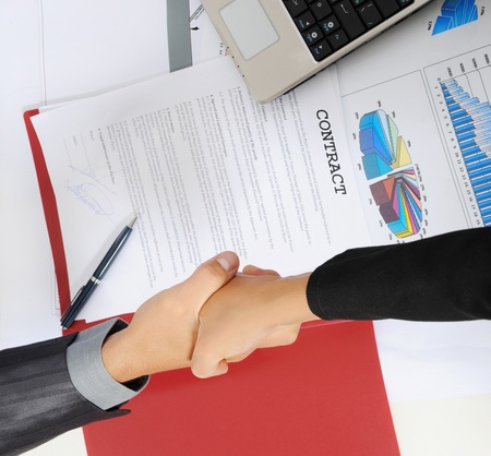 picture of handshake two business partners, when signing contract.の写真素材