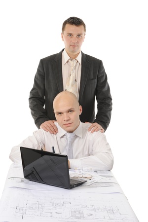 two businessmen in a business suit at a table in a bright office. Isolated on white backgroundの写真素材