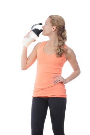 athletic young woman with protein shake bottle. Isolated on white backgroundの写真素材