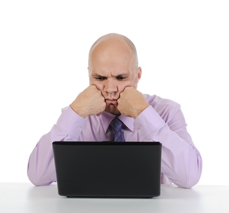 Frustrated man in front of computer. Isolated on white backgroundの写真素材