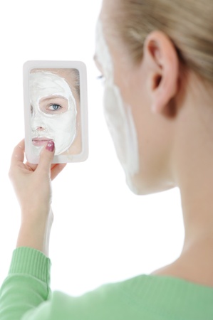 young woman making a spa mask on your face. Isolated on white backgroundの写真素材