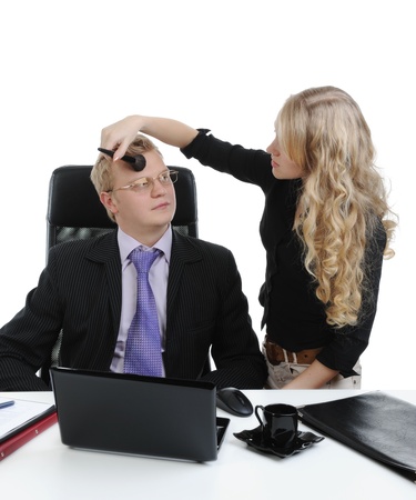 secretary doing make-up to the boss. Isolated on white backgroundの写真素材