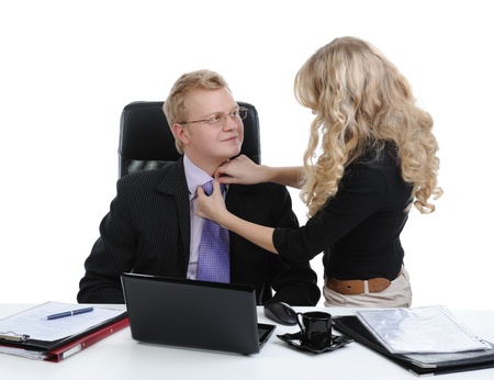 Secretary corrects the director tie. Isolated on white backgroundの写真素材