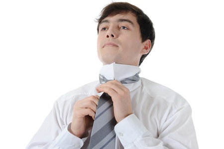 Businessman tying his tie. Isolated on white backgroundの写真素材