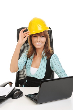 Joyful businesswoman in a helmet in the office. Isolated on whiteの写真素材