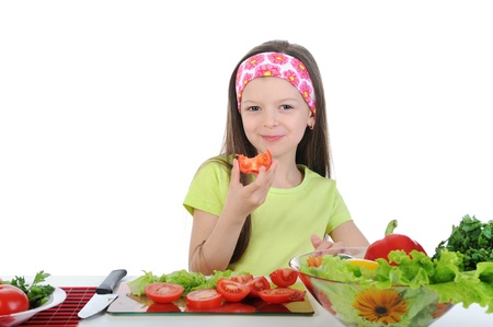 little girl cut fresh tomatoes.の写真素材