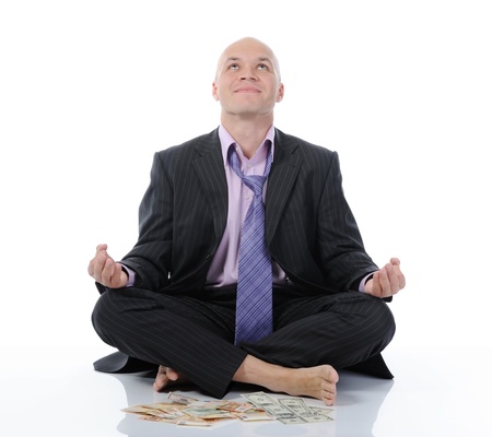 businessman meditating in yoga lotusの写真素材