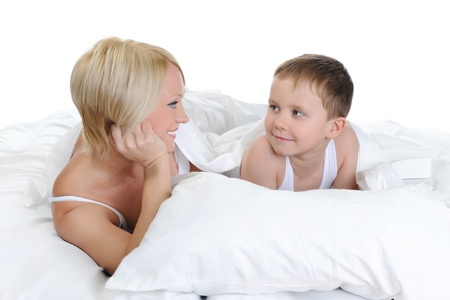 Happy family lying in bedの写真素材