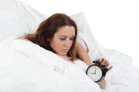 Sleepy woman turns off the alarmの写真素材