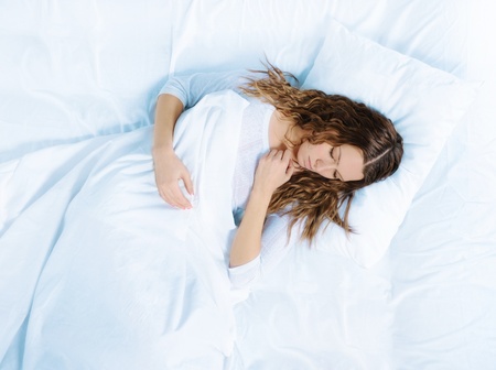 woman sleeping on the bedの写真素材