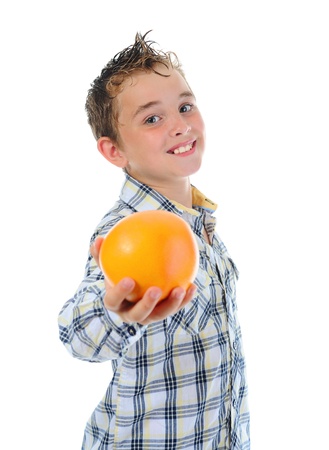 Little kid holding fresh oranges.の写真素材
