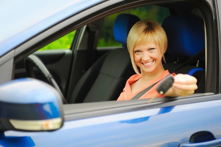 smiling young woman in the carの写真素材