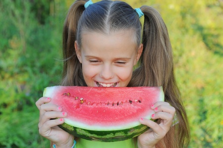 Young girl eating watermelonの写真素材