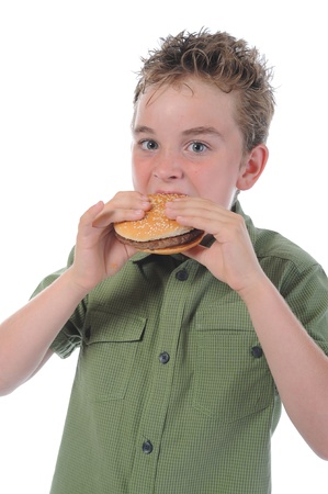 Little boy eating a hamburgerの写真素材