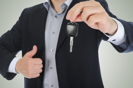 Businessman gives the keys to the carの写真素材