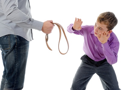 Strict father punishes his sonの写真素材