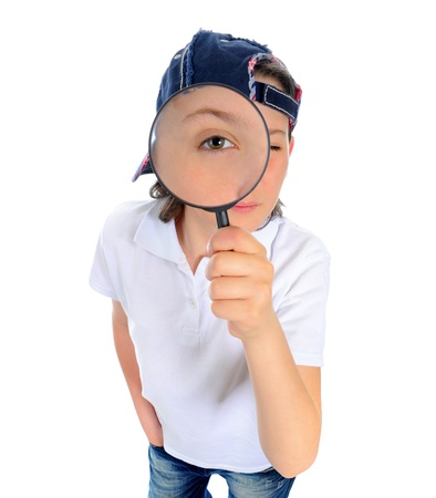 boy looking through a magnifying glassの写真素材