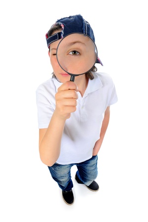 boy looking through a magnifying glassの写真素材