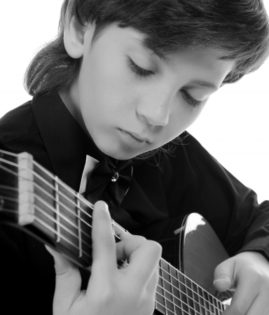 Little boy musician playing guitarの写真素材