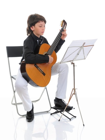 Little boy musician playing guitarの写真素材