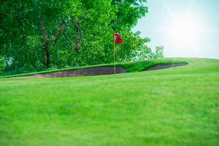 Golf club. Green golf field and ball in grassの写真素材