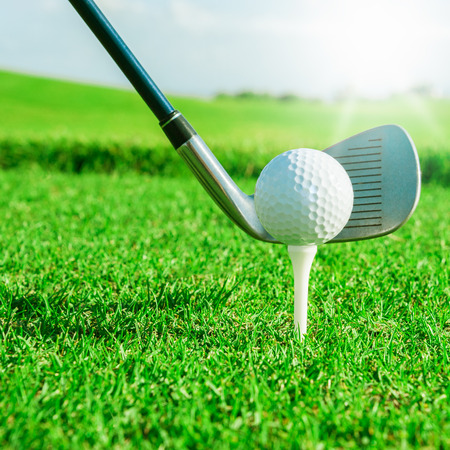 Golf club  Green golf field and ball in grassの写真素材