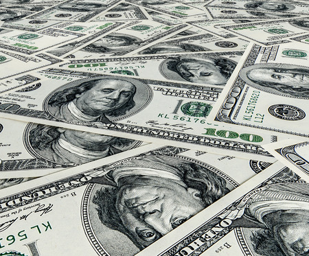 One hundred US dollars bills pile as background
