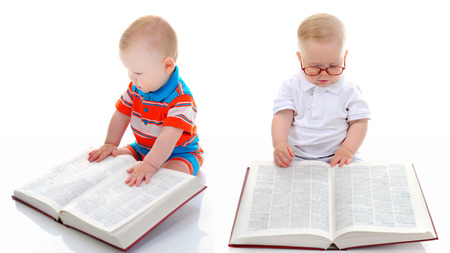 Little smart boy reads a big book  Isolated on white backgroundの写真素材