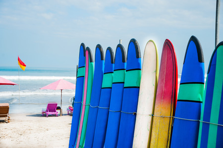 Set of color surf boards in a stack by oceanの写真素材