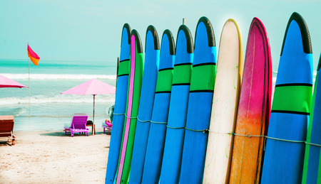 Set of color surf boards in a stack by oceanの写真素材
