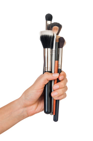 Professional make-up brush cosmetic in female hand beautician isolated on white backgroundの写真素材