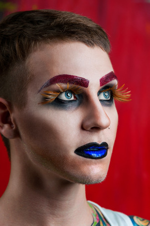 Close-up portrait of the handsome young man fashion model with make-up and big eyelashesの写真素材