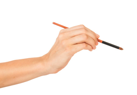 Professional make-up brush cosmetic in female hand beautician isolated on white backgroundの写真素材