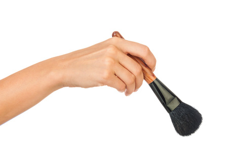 Professional make-up brush cosmetic in female hand beautician isolated on white backgroundの写真素材