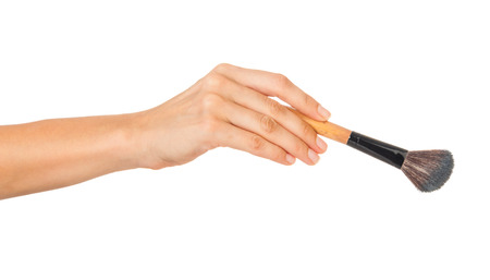 Professional make-up brush cosmetic in female hand beautician isolated on white backgroundの写真素材