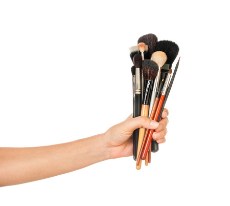 Professional make-up brush cosmetic in female hand beautician isolated on white backgroundの写真素材