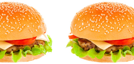Big beautiful juicy burger with meat and vegetables. Isolated on white backgroundの写真素材