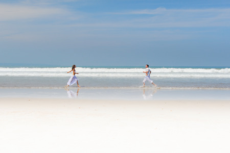 Young beautiful couple in love on a sunny beachの写真素材