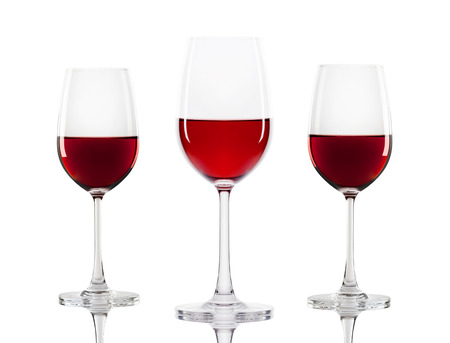red wine in a glass isolated over white backgroundの写真素材