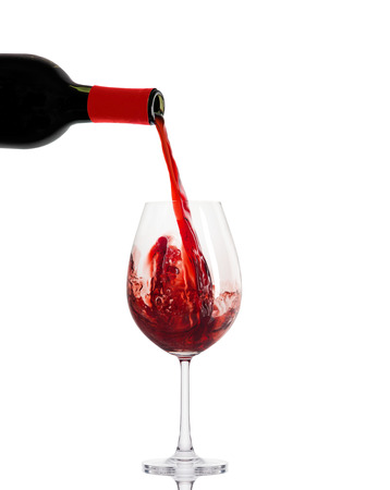 red wine in a glass isolated over white backgroundの写真素材