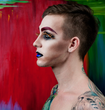 Close-up portrait of the handsome young man fashion model with make-up and big eyelashesの写真素材
