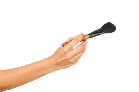 Professional make-up brush cosmetic in female hand beautician isolated on white backgroundの写真素材