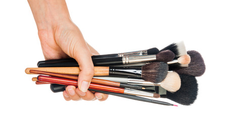 Professional make-up brush cosmetic in female hand beautician isolated on white backgroundの写真素材