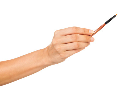 Professional make-up brush cosmetic in female hand beautician isolated on white backgroundの写真素材