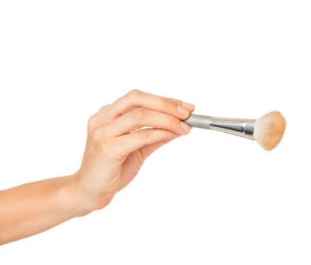 Professional make-up brush cosmetic in female hand beautician isolated on white backgroundの写真素材