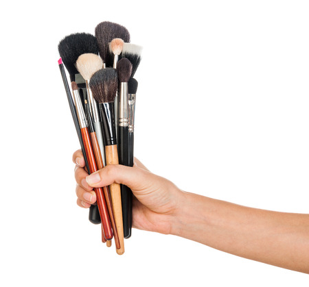 Professional make-up brush cosmetic in female hand beautician isolated on white backgroundの写真素材
